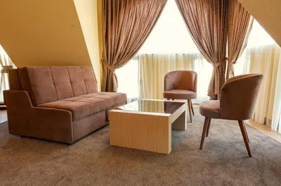 a living room with a couch and two chairs at Boutique hotel Provence Бутик хотел Прованс in Petrich