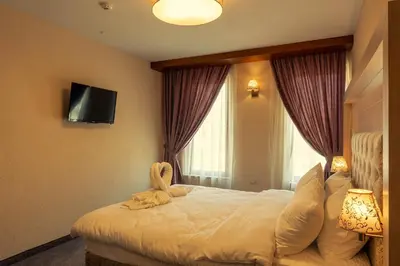 a hotel room with a bed with a towel on it at Boutique hotel Provence Бутик хотел Прованс in Petrich