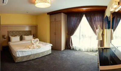 a bedroom with a bed and a large window at Boutique hotel Provence Бутик хотел Прованс in Petrich