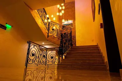 a staircase with a wrought iron railing in a building at Boutique hotel Provence Бутик хотел Прованс in Petrich