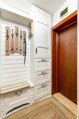 a walk in closet with white cabinets and a wooden door at Stylish 1BD Flat with a terrace near the centre of Plovdiv by Flat Mаnager in Plovdiv