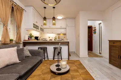 a living room with a couch and a kitchen at Stylish 1BD Flat with a terrace near the centre of Plovdiv by Flat Mаnager in Plovdiv