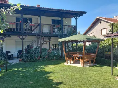a patio with a table and a gazebo at GREEN HOUSE - Попниколови in Sapareva Banya