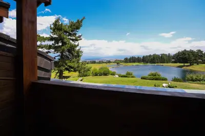 a view of a lake from a window at Lake View House in Bansko