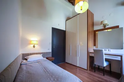 a bedroom with a bed and a desk and a mirror at Lake View House in Bansko