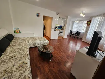 a living room with a couch and a flat screen tv at Апартамент Перла in Sandanski