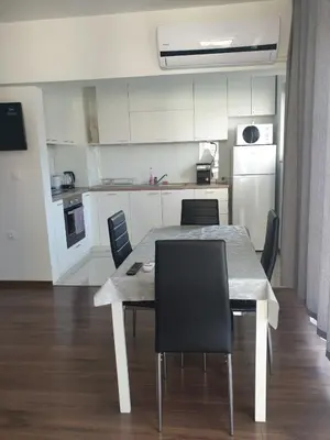 a dining room table and chairs in a kitchen at Апартамент Перла in Sandanski