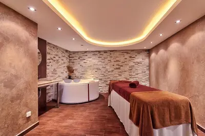 a room with a table in a room with brick walls at Apartments B06 in TERRA complex in Razlog