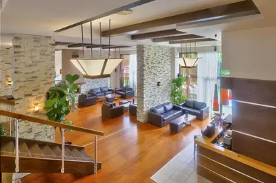 a living room with couches and a stone wall at Apartments B06 in TERRA complex in Razlog