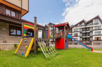 a playground with a slide in a yard at Apartments B06 in TERRA complex in Razlog