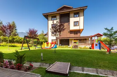 a house with a playground in front of a house at Apartments B06 in TERRA complex in Razlog
