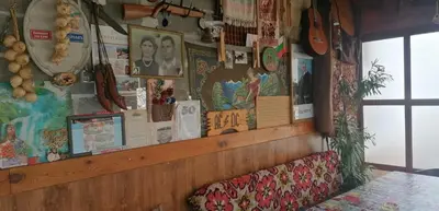 a wall with posters and pictures on it at Роден Край Homeland in Sopot