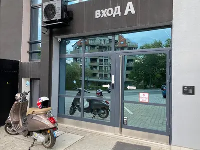 a motor scooter parked in front of a building at Boutique Magenta Gold Apartment in Sofia