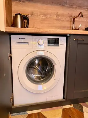 a washing machine in a kitchen with a sink at Boutique Magenta Gold Apartment in Sofia