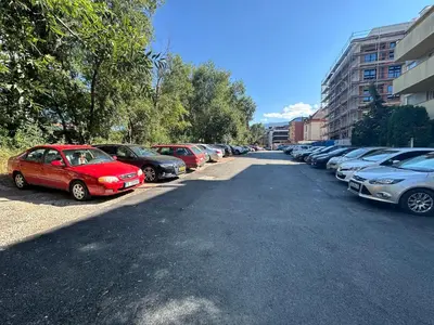 a row of cars parked in a parking lot at Boutique Magenta Gold Apartment in Sofia
