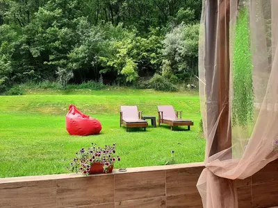 a view of a yard with two chairs and a table at Вила МАЯ in Krayni Dol