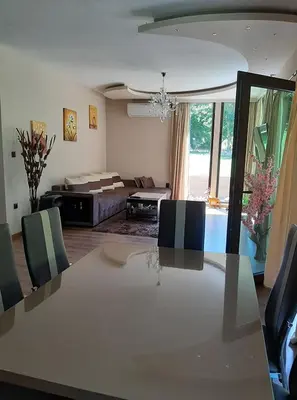 a living room with a table and a couch at Вила МАЯ in Krayni Dol