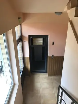 a hallway with a black door in a room at Vega Apartment in Velingrad