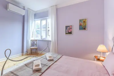 a bedroom with a bed and a window at Chez Marie - Cozy One-Bedroom with Balcony by Flat Mаnager in Sofia