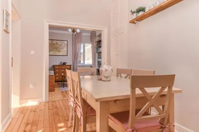 a dining room with a wooden table and chairs at Chez Marie - Cozy One-Bedroom with Balcony by Flat Mаnager in Sofia