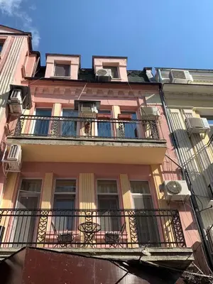 a tall building with a balcony with chairs on it at CENTER APARTMENT PLOVDIV in Plovdiv