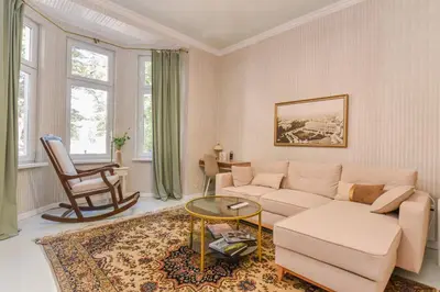 a living room with a couch and a table at Spacious vintage 2BR, 2bath apartment by Flat Mаnager in Sofia