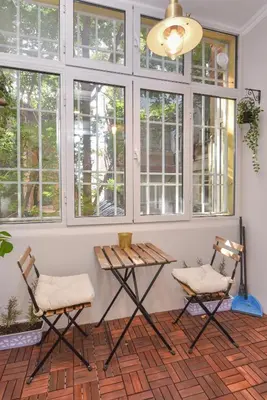 two chairs and a table in a room with windows at Spacious vintage 2BR, 2bath apartment by Flat Mаnager in Sofia
