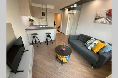 a living room with a couch and a kitchen at LUX 1BD/1BA City Center Apartment in Blagoevgrad