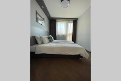 a bedroom with a bed and a window at LUX 1BD/1BA City Center Apartment in Blagoevgrad