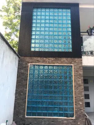 a tall building with blue glass windows on it at Hostel Pop Bogomil in Sofia