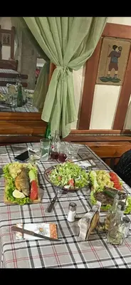 a table with two plates of food on it at Къща за гости Динас in Zmeitsa