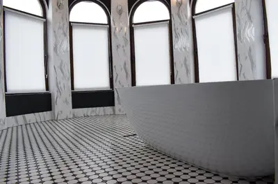 a room with windows and a bench in the middle of a room at Casafamiglia in Prolesha