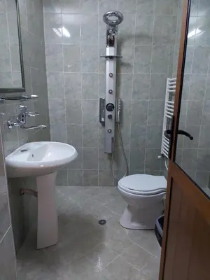 a bathroom with a toilet and a sink at Вила Сладък Живот in Tsigov Chark