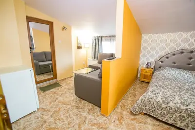 a hotel room with a bed and a mirror at Вила Сладък Живот in Tsigov Chark