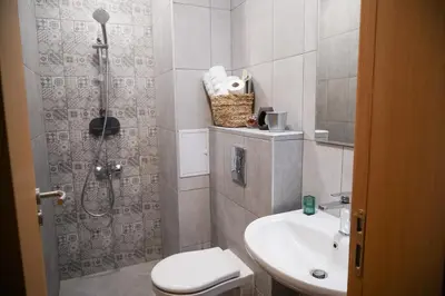 a bathroom with a shower and a toilet and a sink at So Close Kapana - 2 Rooms Central Apartments in Plovdiv