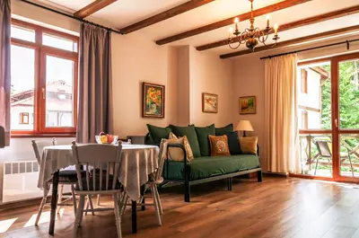 a living room with a green couch and a table at 