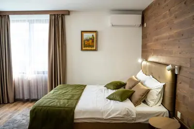a hotel room with a bed and a window at Seven Springs Hotel in Banya