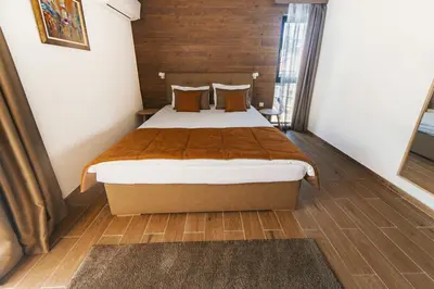 a bedroom with a large bed in a room at Seven Springs Hotel in Banya