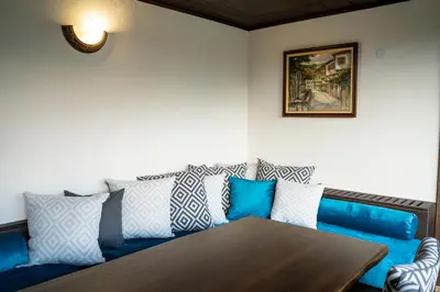 a living room with a couch and a wooden table at Seven Springs Hotel in Banya
