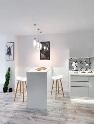 a white kitchen with white counters and stools at Beautiful Place in The Heart of The City!!!! in Plovdiv