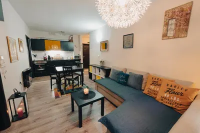 a living room with a couch and a table at Max Holiday Apartment in Pamporovo
