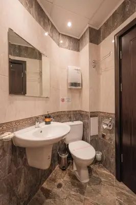 a bathroom with a toilet and a sink at Max Holiday Apartment in Pamporovo