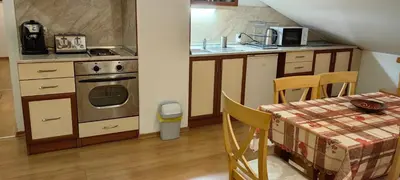 a kitchen with a stove and a table with a tablecloth at Two bedroom flat in Magernitsa in Bansko