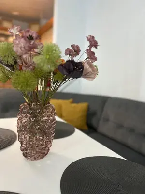 a vase filled with flowers sitting on a table at Sandanski Apartments Park Center in Sandanski
