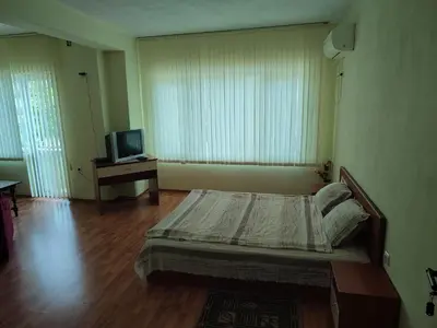 a bedroom with a bed and a television in it at Хотелски Комплекс Авалон in Asenovgrad