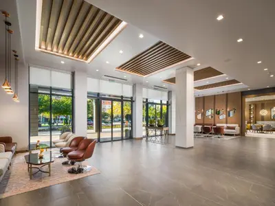 a lobby with a couch and chairs and tables at Hotel Jägerhof in Plovdiv