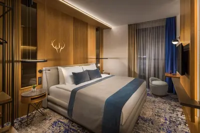 a hotel room with a bed and a bathroom at Hotel Jägerhof in Plovdiv