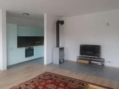 a living room with a flat screen tv and a piano at Комплекс Падалото 