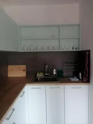 a kitchen with white cabinets and a sink at Комплекс Падалото 