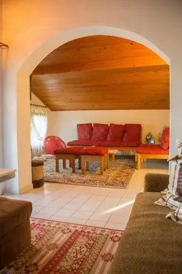 a living room with a couch and a table at вила Топи in Kaloyanovo